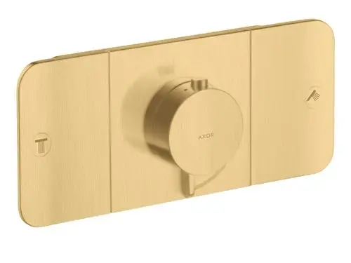 Thermostatmodul in gebürsteter Goldoptik von AXOR mit einem zentralen Einstellrad und Symbolen für Temp- und Duschsteuerung. Dezentralisierte Montage für zwei Verbraucher.